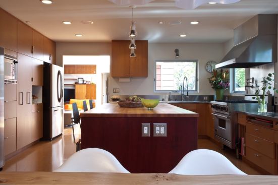 Formaldehyde-free cabinets, salvaged Douglas-fir flooring, and energy-efficient appliances and lighting are featured in the kitchen.