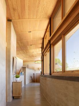 Rammed-earth walls on the exterior and interior are shaded to remain cool in the summer; in winter, the sun warms the walls, which slowly release heat into the home.