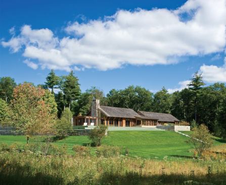 The house occupies a ridge with a clearing and view to the south.