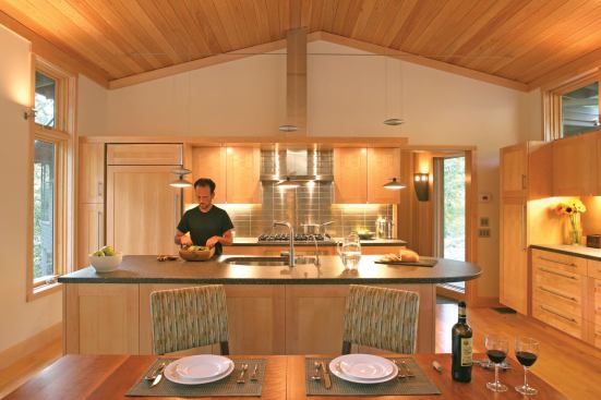The project features an attractive kitchen loaded with features like local custom maple cabinets, recycled-content concrete countertops, Energy Star-rated appliances, low-voltage lighting, and a low-flow faucet.