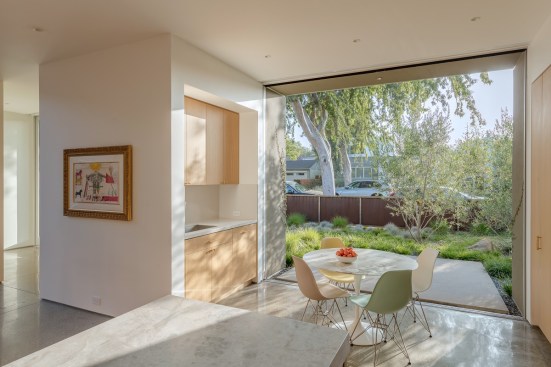 Breakfast Nook: With the front facing east, the design team added a glass front door and a two-panel pocket door off the nook for lots of natural light in the morning.