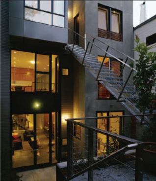 The most dramatic feature of the project is a central stair fabricated from steel plate and acrylic. A party wall, angled from front to back, creates further interest by dividing the building envelope into two trapezoidal spaces, each with one end wide and the other narrow.