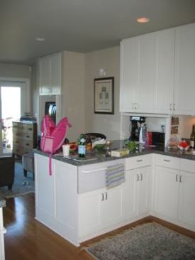 The previous kitchen "had this awkward pinch," says architect Anne Adams. "The peninsula backed up to the fridge, so the spot where everyone congregated was right there."