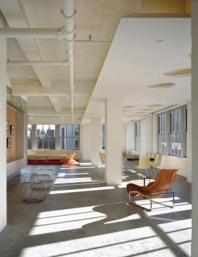 At Cooper Square, spun aluminum dome cutouts define the dining area and hide drainage pipes coming from the roof. Dimmable xenon fixtures create an even wash of light.