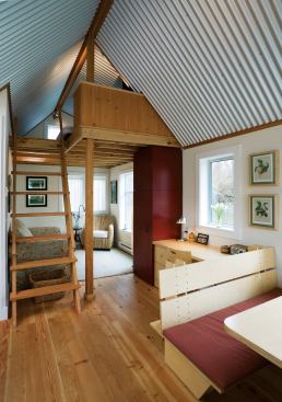 The abundant use of windows, reflective materials, and built-in storage keeps the small space from feeling claustrophobic. 