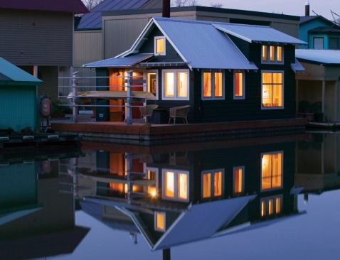 Rugged on the outside, light and airy inside, the houseboat's finger-jointed cedar shingle siding recalls a fishing cabin.