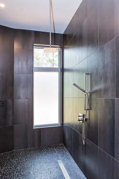 A mostly frosted window lets natural light enter the master shower without sacrificing privacy.