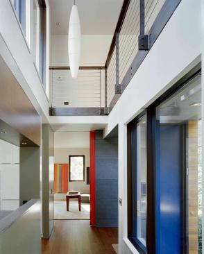 Once something of a tunnel, the entry hall now opens to adjacent spaces and the outdoors.