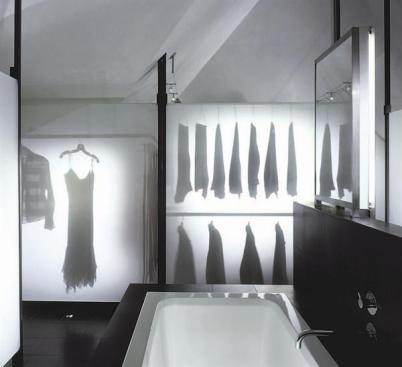 The judges were struck by the ghostly quality of the clothes' shadows on the laminated glass. A white Venetian plaster finish on the walls and ceiling allows light to bounce around the room.