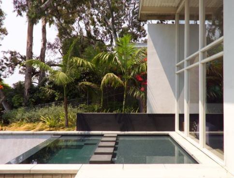 The reflecting pool, in conjunction with the operable panel doors, help to cool the space.