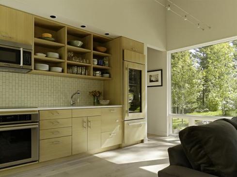 Guests often comment on the vertical subway tile in the kitchen, Carney says. The 12-foot-long space echoes the serene palette of the rest of the project.