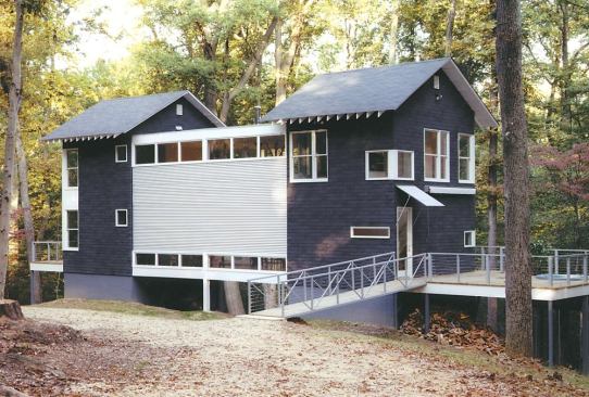 An exterior wall of corrugated metal reverses to a blank white canvas for a custom-designed light sculpture (next picture).