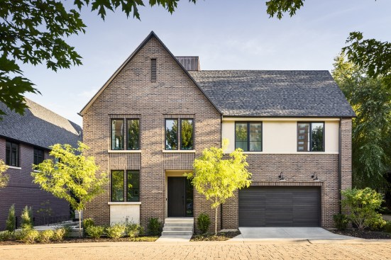 Although similar to its sister house, Courtyard House’s brick exterior is complemented by stucco banding on the second floor.