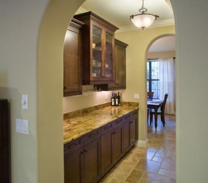 Higlighted by a decorative fixutre lit by compact flourescent bulbs, the butler's pantry is an important gateway -- with an entry door off the garage -- and a link between the kitchen and dining room.
