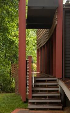 This organically inspired addition and renovation of a wedge-shaped, brick-faced 1970s home responds to its forested views while adding a texturally rich layering of decks, terraces, screens, railings, and outdoor living space.