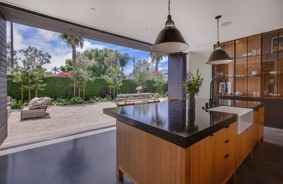 The family room area has feels connected to the outdoors through pocket doors on both sides.