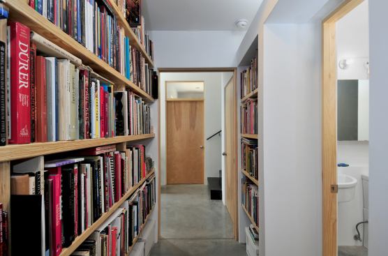 Built-in bookcases of microlam turn the hallway into a library.