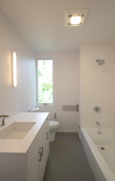 The simple baths feature ceramic tiled floors and water-saving plumbing products from Kohler.
