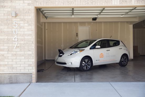 The four-car garage is equipped with an electric vehicle charging station.