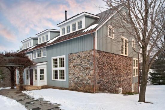 The stone wall on this rebuilt barn was one of the only elements left standing after the fire.
