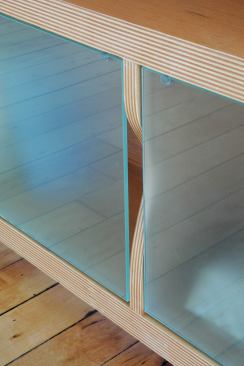 The loft space made uninterrupted straight lines nearly impossible; the firm found a workaround with custom built-in millwork and storage units.