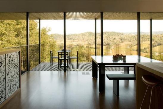 Linear floor planks that allow light to pass through them are mirrored by a surrounding railing and ceiling beams that allow this porch to ease the visual transition from indoors to out. Project: House for Locavore Farmers, Sonoma, Calif.; Architect: Cooper Joseph Studio, New York; Builder: Red Horse Constructors, San Rafael, Calif.