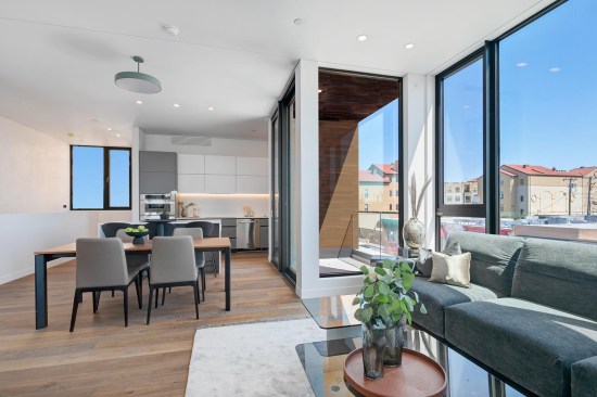 The second-floor main living areas feature modern kitchens that spill into the dining and lounging areas.