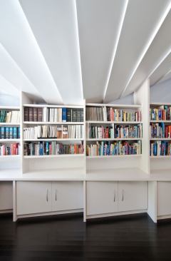 Segmenting the shelves creates an automatic organizational mechanism for sorting the books into different categories within the four-foot sections.