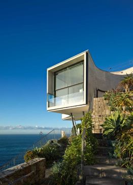The house rises in a series of terraces that seem to grow out of the native geology.