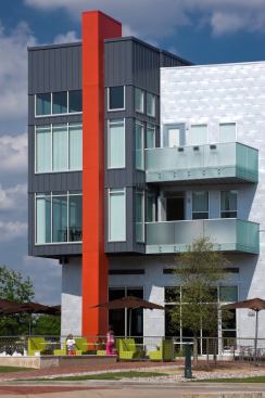 In a northern Dallas suburb, a bright red column anchors this mid-rise. The project is mixed-use, with lofts, apartments, townhomes, and retail. 
Project: Austin Ranch, The Colony, Dallas; 
Architect: JHP Architecture/Urban Design, Dallas; 
Builder: Westwood Residential, Plano, Texas