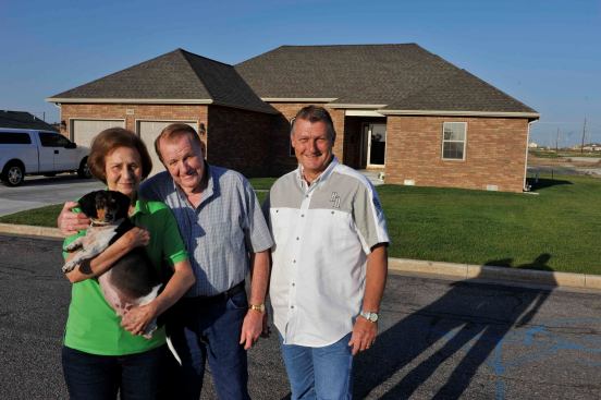 Eileen and Everett Wallace, builder Gary Rose, and dog Gus in front of the Wallace’s new home in Joplin. Said Eileen, “Gary was the only builder I knew. I trusted Gary, and I knew he wasn’t going to leave town.”