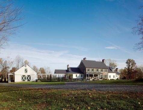 The linear room arrangement offers a range of perches from which to view the 80-acre property, which slopes away behind the house. 