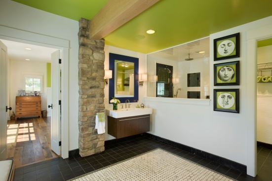 The master bath features a large shower with a foyer so the homeowner can maneuver her chair easily into the shower. Fixed glass lets natural light flow into the wet room.