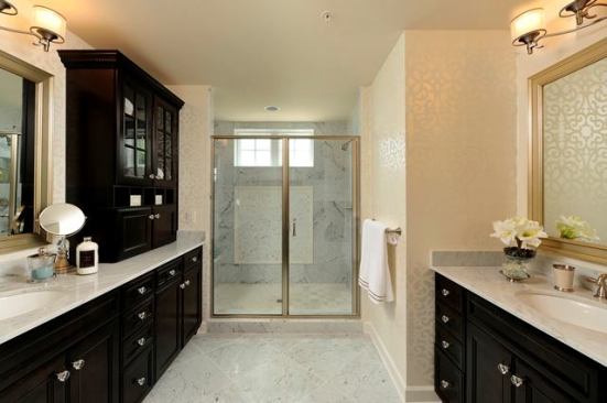 The master bath is appointed with granite counters, porcelain undermount sinks, 12-inch ceramic floor tiles, and 9-inch-by-12-inch wall tiles.
