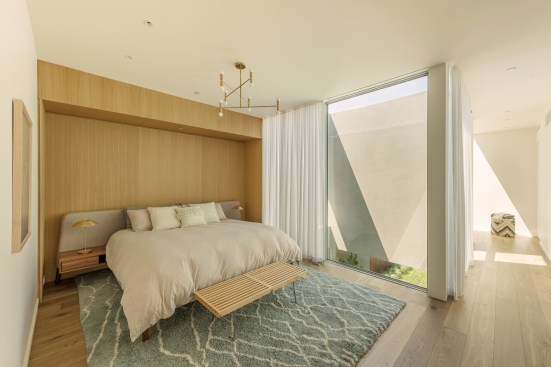 Master Living: Natural light floods the upstairs master suite through the atrium window walls and skylights scattered from the closet to the bathtub and shower.