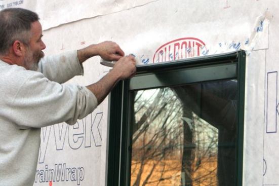 Skip-Tape the HeadI "skip-tape" (apply short pieces of tape with gaps in between) the lower edge of the flap in place. Note: These skip-taped gaps act as weeps, giving any moisture that gets to the window head a way to escape.