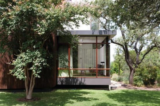 In this Texas home, a glass corner window accented by clean wood lines allows owners to take full advantage of this site’s serene setting and old growth trees from the comfort of conditioned space. Project: Lakeview Residence, Austin, Texas; Architect: alterstudio, Austin