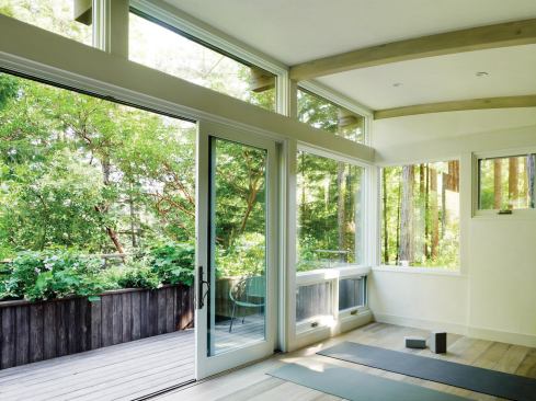 Clerestories and glass walls bring the lush scenery into the yoga studio.