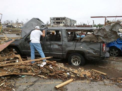 The Huddleston’s totaled Chevy Suburban after the tornado. The vehicle was picked up and carried by the storm, less than a block from the safety of their home’s basement. Emily Huddleston was severely injured; the rest of the family also received injuries from windborne debris.
