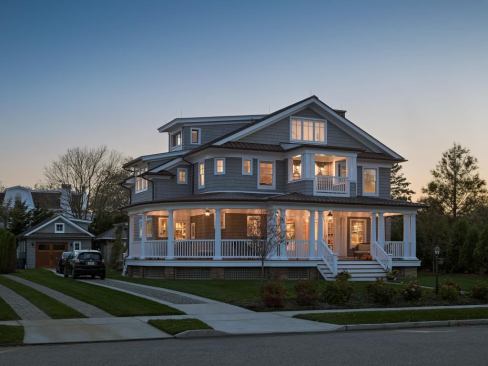 "In this particular beach town and neighborhood, porches are a huge design element,” says Bubnowski. Entrance steps are 12 feet wide, and it's the favorite spot for portraits taken during family gatherings. The original porch was 13 feet deep, and the scale has been maintained.