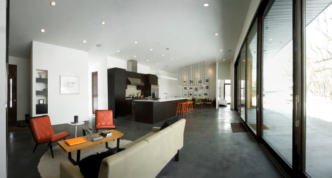 Inside, an open floor plan with clean lines and concrete floors helps to draw attention outward to the scenery beyond.