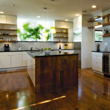 The open, wood-clad kitchen in the Post Oak residence.