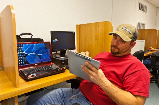 Worker Ken Burley relaxes at the Internet Cafe inside the Bear Paw lodge in North Dakota