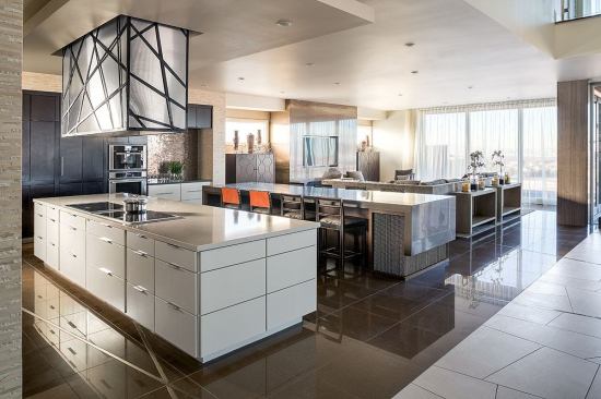 Interiors are both soothing and sparkling, Monolithic stretches of stone, wood, and tile are punctuated by metallic and glass accents.