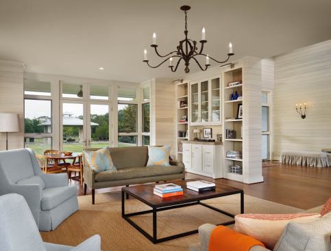 Walls of glass protected by deep overhangs flank open living spaces.