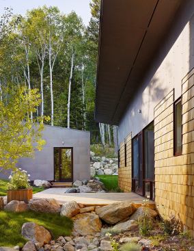 The colors of the cedar shingles and bonderized steel play off the landscape’s natural hues.