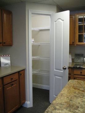 Patco Construction replaces awkward corner cabinet storage with a useful corner pantry.
