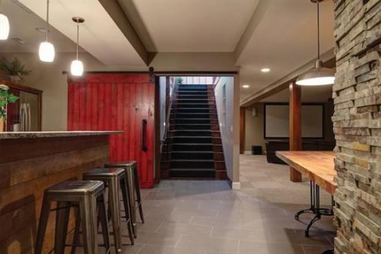 Red punches up this sliding barn-style door. The bright hue adds interest while staying in character with the home’s Midwestern farm house aesthetic. Project: Woodland Hall House, Columbus, Ohio; Architect: Meyers + Associates, Columbus; Builder: Ghiloni Custom Builders, Granville, Ohio