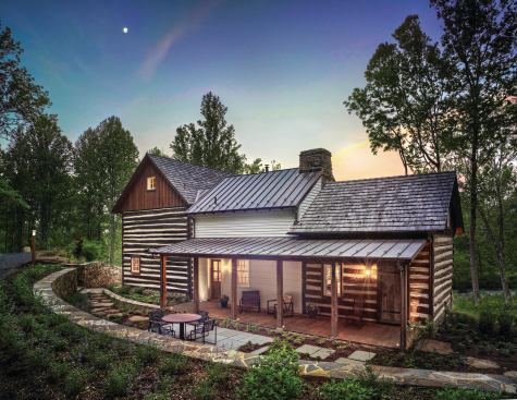 Cedar shakes cover the roofs of the cabins, while standing seam metal tops the addition and porch.