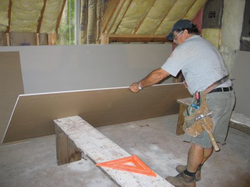 Otherwise, he uses two 18-inch-high benches as a work platform, tilting each panel against their ends and then dragging it on top.